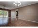 Open-concept living room with hardwood floors, ceiling fan, and patio access at 2971 Estancia Blvd # 328, Clearwater, FL 33761