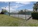 Outdoor tennis court surrounded by a tall fence and lush greenery at 2971 Estancia Blvd # 328, Clearwater, FL 33761