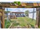 Relaxing backyard featuring a covered patio, swing set, and well-maintained lawn at 3042 57Th N Ave, St Petersburg, FL 33714