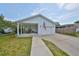 Inviting single-story home featuring a covered porch, a garage, manicured lawn, and an American flag at 3042 57Th N Ave, St Petersburg, FL 33714