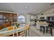 Bright kitchen with white cabinets, black appliances, island, and adjacent dining area with large display cabinet at 3042 57Th N Ave, St Petersburg, FL 33714