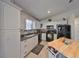 Bright kitchen featuring white cabinets, tile flooring, and granite countertops at 3042 57Th N Ave, St Petersburg, FL 33714