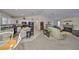 Open-concept living space featuring a modern kitchen with black appliances, a dining area, and a living room with a fireplace at 3042 57Th N Ave, St Petersburg, FL 33714