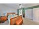 Bright bedroom with green accent wall, plush carpet, and two dressers for storage at 3042 57Th N Ave, St Petersburg, FL 33714