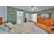 Cozy main bedroom featuring a ceiling fan, craftsman dresser with mirror, and ensuite bathroom access at 3042 57Th N Ave, St Petersburg, FL 33714