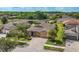 Aerial view of a house with three-car garage, gorgeous landscaping, and neighborhood lake at 3204 Mapleridge Dr, Lutz, FL 33558
