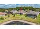 Aerial view of a home with a large backyard, pond, and neighboring houses in a residential community at 3204 Mapleridge Dr, Lutz, FL 33558