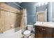 Neat bathroom features shower-tub combo, and vanity with dark wood cabinets at 3204 Mapleridge Dr, Lutz, FL 33558