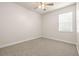 Neutral bedroom featuring soft carpet, and a window letting in ample natural light at 3204 Mapleridge Dr, Lutz, FL 33558