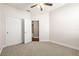 Unfurnished bedroom featuring soft carpet, closet with doors, and an adjoining bathroom at 3204 Mapleridge Dr, Lutz, FL 33558