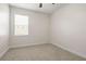 Bright, unfurnished bedroom offers soft carpet, and a window letting in ample natural light at 3204 Mapleridge Dr, Lutz, FL 33558