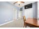Comfortable bedroom with neutral carpet, ceiling fan, and large desk at 3204 Mapleridge Dr, Lutz, FL 33558