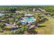 Community pool featuring ample seating, shade structures, playground, and lush landscaping at 3204 Mapleridge Dr, Lutz, FL 33558