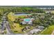 Aerial view of the community pool, clubhouse, and amenities surrounded by lush landscaping at 3204 Mapleridge Dr, Lutz, FL 33558