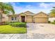 Beautiful single-Gathering home featuring a three-car garage and well-manicured landscaping at 3204 Mapleridge Dr, Lutz, FL 33558