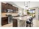 Kitchen with stainless steel appliances, dark wood cabinetry and granite countertops at 3204 Mapleridge Dr, Lutz, FL 33558