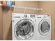 Modern laundry room featuring a side-by-side washer and dryer at 3204 Mapleridge Dr, Lutz, FL 33558