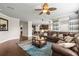 Open-concept living room showcases dark wood floors, large leather couch, and views into the kitchen at 3204 Mapleridge Dr, Lutz, FL 33558