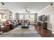 A large living room with hardwood floors, a ceiling fan, and a leather couch at 3204 Mapleridge Dr, Lutz, FL 33558