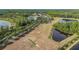Aerial view of the community recreation field, sports field, ponds, and surrounding greenery at 3204 Mapleridge Dr, Lutz, FL 33558