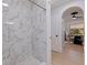Newly tiled shower and archway view into dining room enhances this stylish renovated bathroom at 3230 Queensboro S Ave, St Petersburg, FL 33712