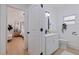 Clean bathroom with a white vanity, modern fixtures, and a view into the primary bedroom at 3230 Queensboro S Ave, St Petersburg, FL 33712