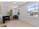 Bright, airy bonus room featuring light-colored floors, large windows and modern black accent chairs at 3230 Queensboro S Ave, St Petersburg, FL 33712