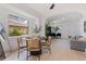 Open dining room with a stylish round table, woven chairs, and an abundance of natural light at 3230 Queensboro S Ave, St Petersburg, FL 33712