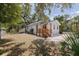 Landscaped yard surrounds this cozy home with a charming wooden porch, perfect for enjoying outdoor living at 3230 Queensboro S Ave, St Petersburg, FL 33712