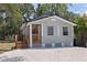 Charming home featuring a light gray exterior, a small wooden porch, and a well-maintained yard at 3230 Queensboro S Ave, St Petersburg, FL 33712