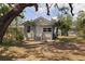 Charming single-story home with a well-manicured lawn and mature trees at 3230 Queensboro S Ave, St Petersburg, FL 33712
