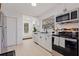 Well-lit kitchen features stainless steel appliances, sleek countertops, and opens to a cozy seating nook at 3230 Queensboro S Ave, St Petersburg, FL 33712