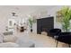 Bright living room with a modern fireplace, neutral decor, and seamless flow into the dining area at 3230 Queensboro S Ave, St Petersburg, FL 33712