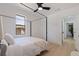 Bright main bedroom features a four-poster bed frame and natural light from the large windows at 3230 Queensboro S Ave, St Petersburg, FL 33712