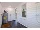 Utility room with water heater, dark floors, and access to the kitchen at 3230 Queensboro S Ave, St Petersburg, FL 33712
