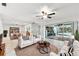 Virtual staged living room with comfortable seating and views of the outdoor pool area at 3351 San Jose St, Clearwater, FL 33759