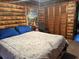 Comfortable bedroom featuring log-style wallpaper, a soft bed, and ample closet space at 3405 Holland Dr, Brandon, FL 33511