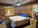 Unique bedroom featuring log-style wallpaper, a comfortable bed, and natural lighting at 3405 Holland Dr, Brandon, FL 33511