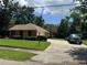 Beautifully landscaped home with a large driveway and lush green lawn offering great curb appeal at 3405 Holland Dr, Brandon, FL 33511