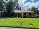 Charming brick home with lush green lawn and mature trees offering a serene curb appeal at 3405 Holland Dr, Brandon, FL 33511