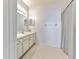 Well-lit bathroom featuring tile floors, vanity and shower with tub at 3456 High Hampton Cir, Tampa, FL 33610