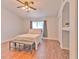 Bright bedroom featuring hardwood floors, ceiling fan and natural light from the window at 3456 High Hampton Cir, Tampa, FL 33610