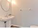 Stylish half-bathroom featuring a pedestal sink and modern finishes at 3456 High Hampton Cir, Tampa, FL 33610