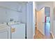 Practical laundry area with appliances, shelving, and access to other rooms at 3456 High Hampton Cir, Tampa, FL 33610
