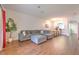 Spacious living room featuring wood-look tile, gray sectional sofa and view of dining area at 3456 High Hampton Cir, Tampa, FL 33610