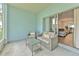 Cozy outdoor patio with wicker furniture, perfect for relaxing or entertaining near the sliding glass door at 3456 High Hampton Cir, Tampa, FL 33610