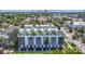 Aerial shot of modern townhomes featuring rooftop decks and sleek exteriors, located in a desirable urban area at 4215 W North A St # 3, Tampa, FL 33609