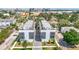 Aerial view of modern townhomes with rooftop decks, landscaping, and paved driveways at 4215 W North A St # 3, Tampa, FL 33609