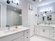 Modern bathroom featuring double sinks, a quartz countertop, sleek hardware, and ample lighting at 4215 W North A St # 3, Tampa, FL 33609