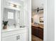 Elegant powder room featuring a large mirror, vanity with white cabinets, and stylish light fixture at 4215 W North A St # 3, Tampa, FL 33609